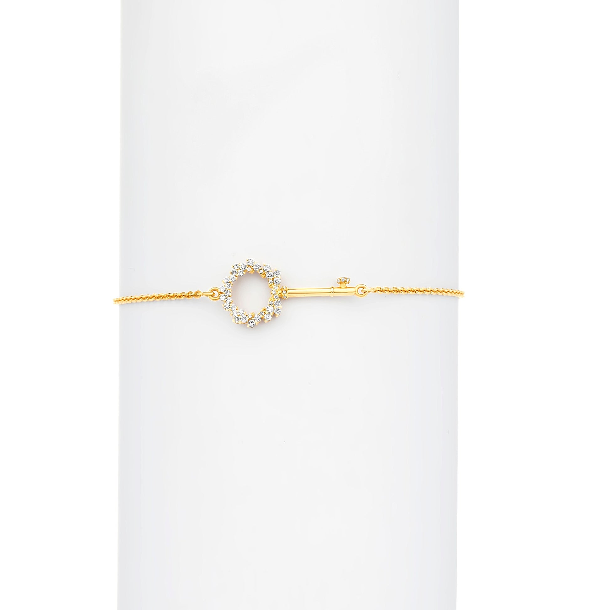 Gold bracelet with a circular design on a white background